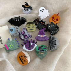 Assorted Halloween hair accessories featuring glitter and character designs