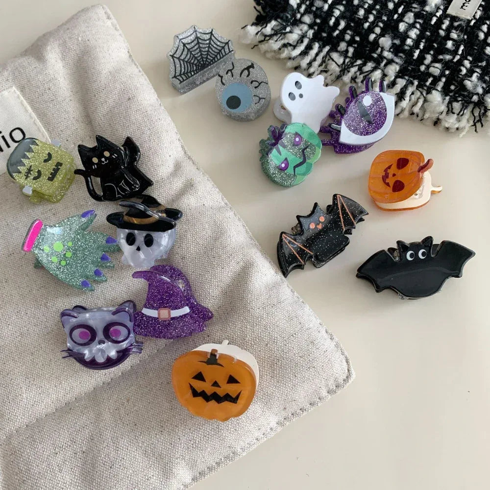 Various Halloween hair clips laid out on a textured surface