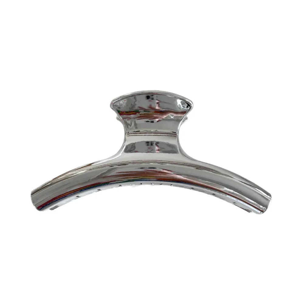 Silver metallic claw clip with a curved design and ridged interior