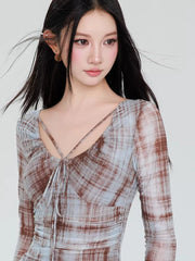 Detail of the sweetheart neckline and criss-cross straps on the plaid mesh dress.