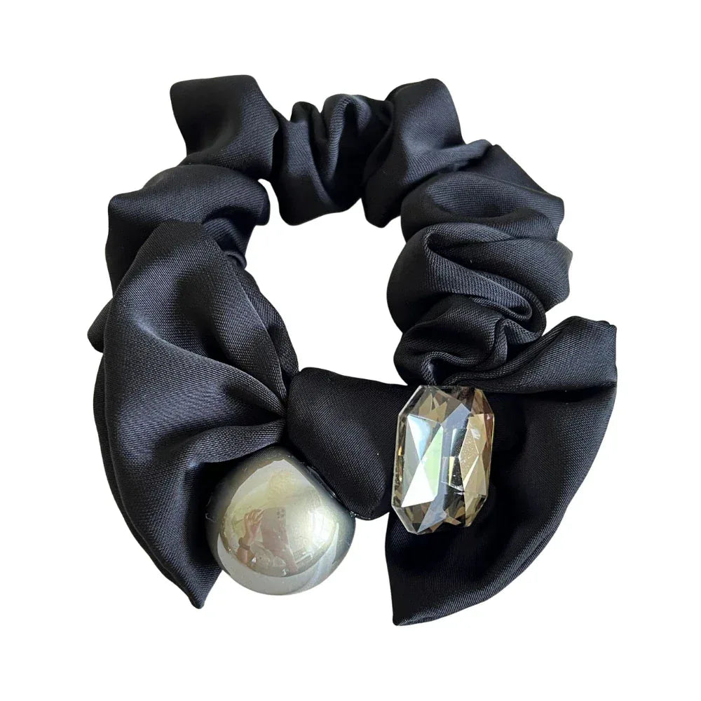 Black satin scrunchie with a metallic sphere and crystal embellishment