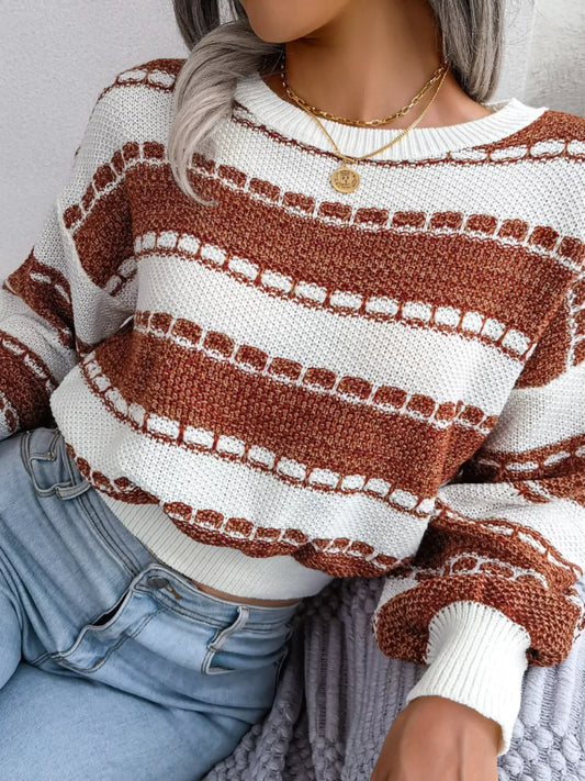 Woman wearing a brown and white striped cropped knit sweater with light wash jeans.