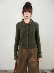 Woman wearing a green cable knit cardigan with a plaid collar