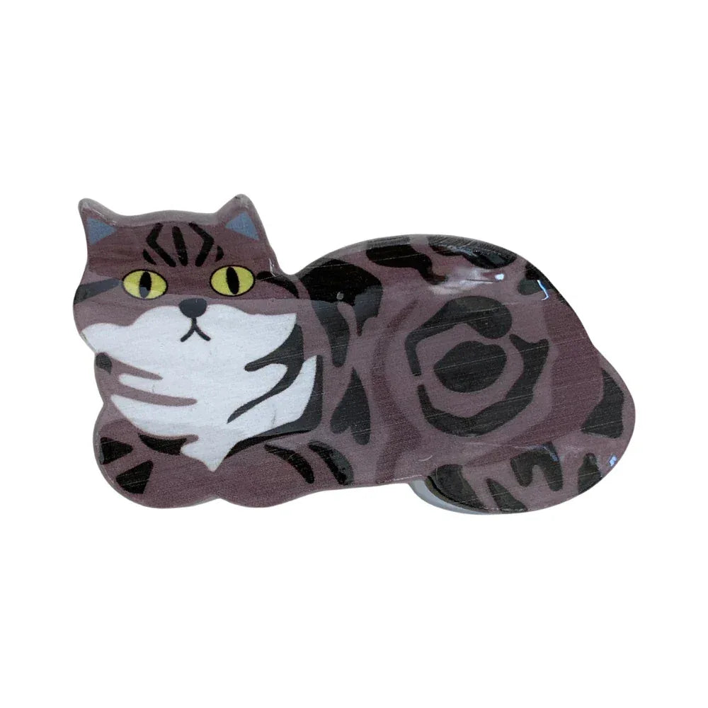 A close-up of a brown tabby cat-shaped hair clip.