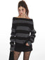 Model wearing a grey and black striped sweater styled off-the-shoulder, black shorts, black tights with stars, and black boots.