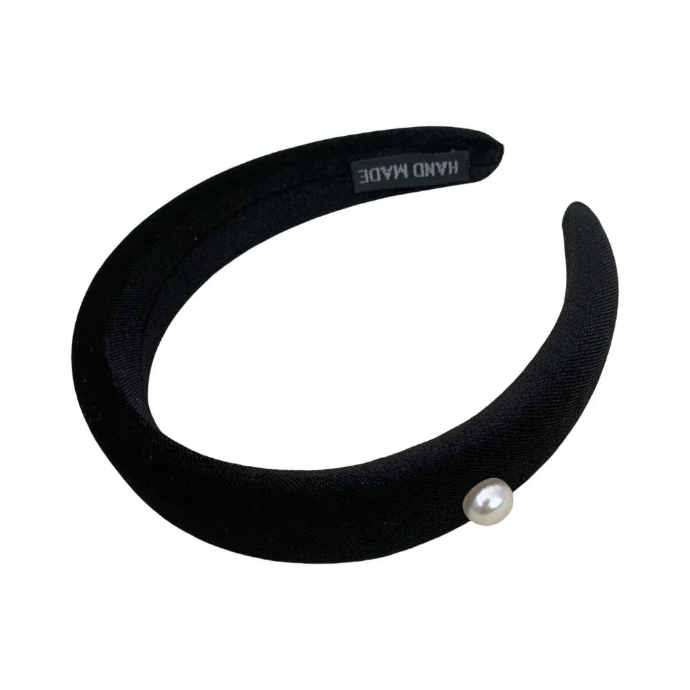 black padded headband with a single pearl accent