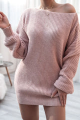 Close-up of a woman wearing a pink off-the-shoulder ribbed knit tunic sweater, showing the texture.