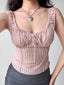 Close-up of a pink striped ribbed knit top with a sweetheart neckline and tie front.