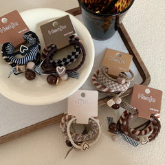 A collection of Henju hair ties displayed on a white plate and a tray.