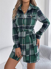 Woman wearing a green plaid long-sleeve belted shirt dress