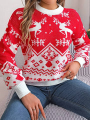 Close-up of a woman in a red and white Christmas sweater with a reindeer pattern, sitting down.