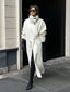 Woman wearing a white oversized wool blend coat with black leather gloves and boots