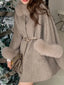 Light grey wool blend cape with fur collar and cuffs, cinched with a belt, worn by a person