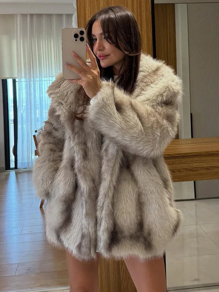 close-up of a woman wearing a light brown oversized faux fur coat