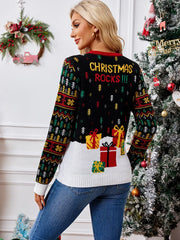 Back view of a woman wearing a black Christmas sweater with a graphic of presents and the text 'CHRISTMAS ROCKS!!!'.