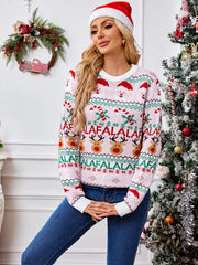 Woman wearing a pink Christmas sweater with Santa, reindeer, and candy cane print, standing in front of a Christmas tree