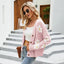 woman wearing a pink floral print knit cardigan