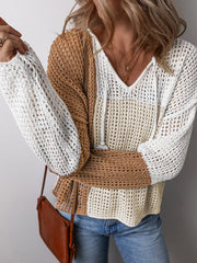 Close-up of a woman wearing a color block knit sweater, showing the texture and details.