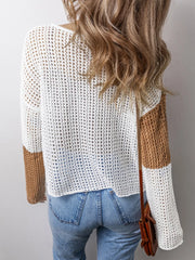 Back view of a woman wearing a color block knit sweater.