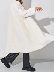 Model twirling in a white faux fur coat