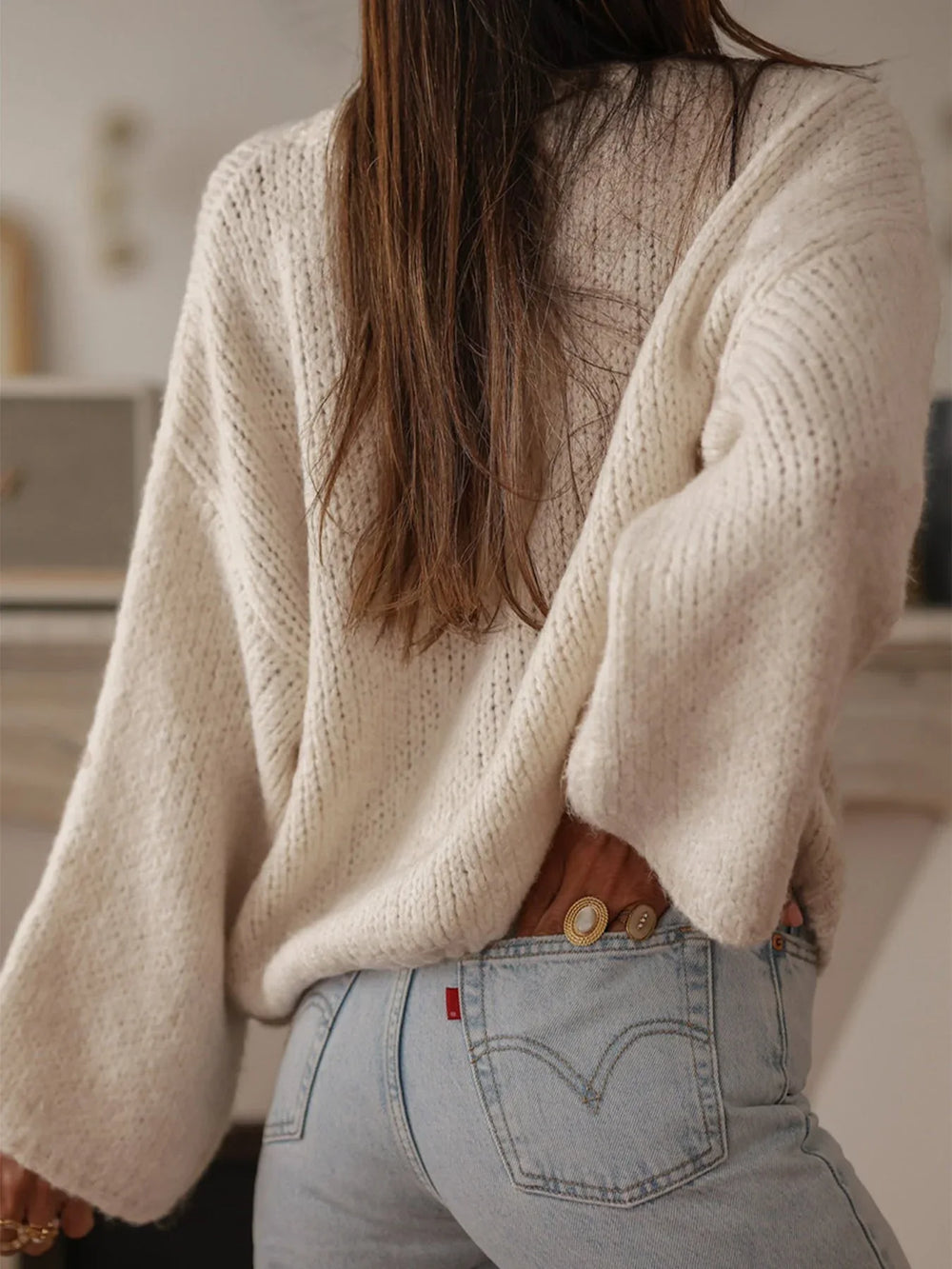 Back view of the cream oversized cardigan, emphasizing the relaxed fit and knit texture.