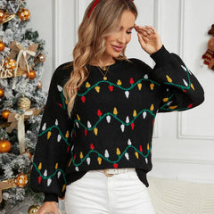 Woman wearing a black knitted sweater with a Christmas lights pattern and a red headband
