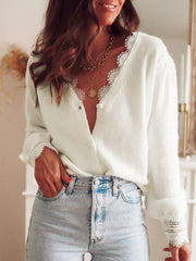 Woman wearing a white knit cardigan with lace trim and jeans