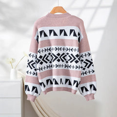 back view of a pink and black geometric print knit cardigan hanging on a wooden hanger