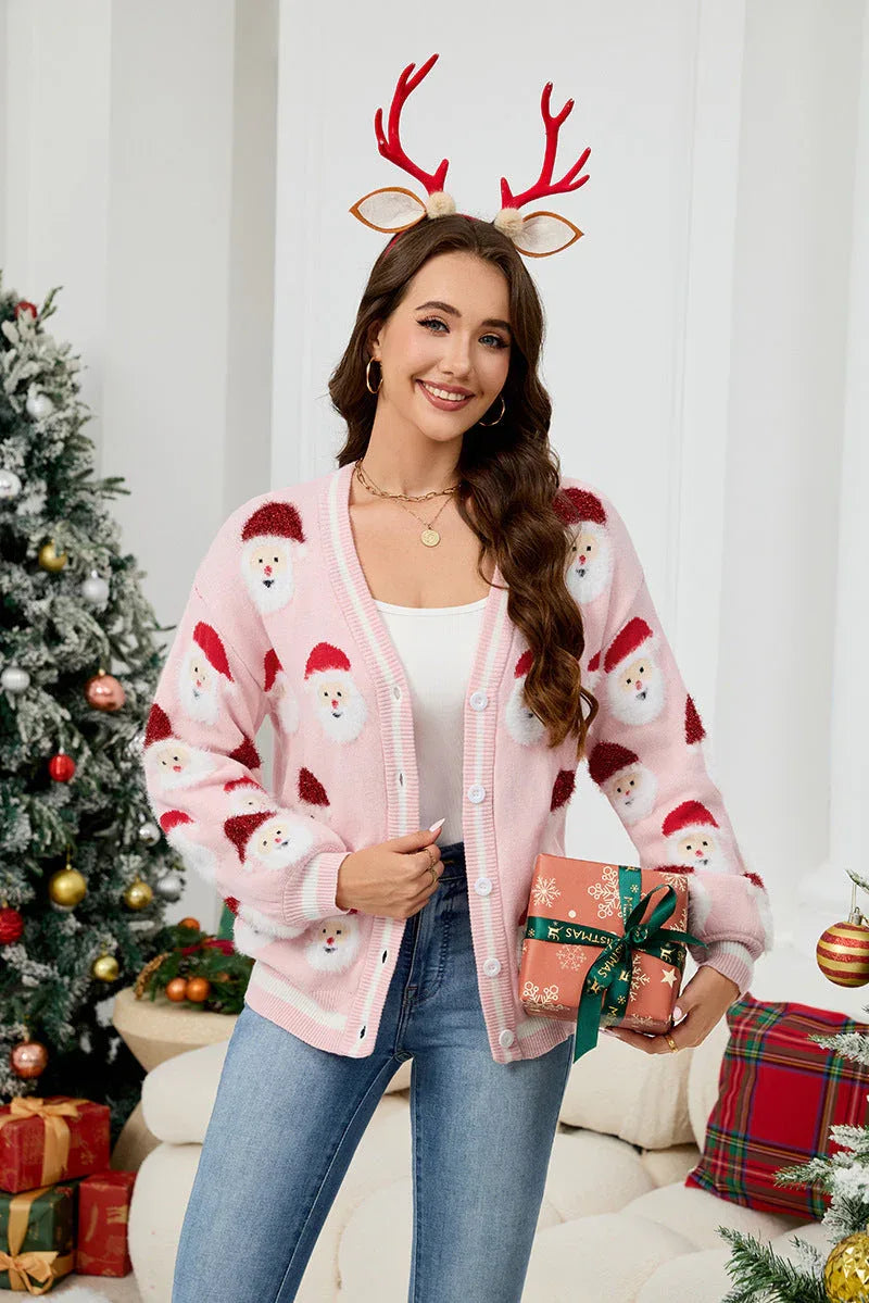 Woman wearing a pink Santa Claus print knit cardigan and holding a gift