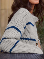 Close-up of the striped knit texture on a gray and blue cardigan.