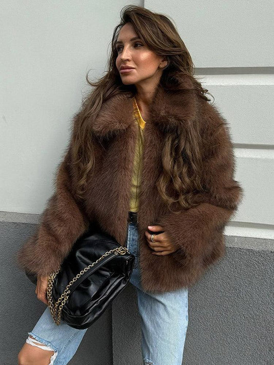 woman wearing a brown faux fur jacket and blue jeans