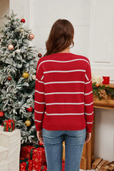 Back view of a woman wearing a red striped Christmas sweater.