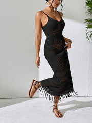 Woman wearing a black crochet maxi dress and sandals