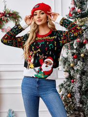 Woman wearing a red beanie and a black Christmas sweater with a graphic of Santa playing guitar and a reindeer, posing in front of a decorated Christmas tree.