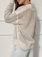 Side view of a woman wearing a cream open knit quarter-zip sweater.