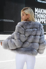 Back view of a woman in a grey faux fur jacket