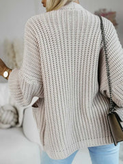 Back view of a woman in a beige knit cardigan