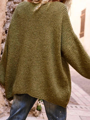 Back view of the green oversized knit sweater, showing the textured knit and relaxed fit.