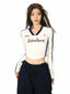 Front view of a woman in a white cropped long-sleeve shirt with contrast trim and 'RetroSport' graphic.