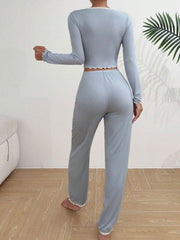 Back view of a woman in a light blue ribbed knit pajama set.
