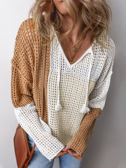 Front view of a woman wearing a color block knit sweater with a v-neck and drawstring hood.