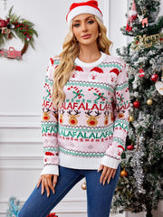 Woman in a festive pink knitted sweater with holiday motifs, posing with a large candy cane prop