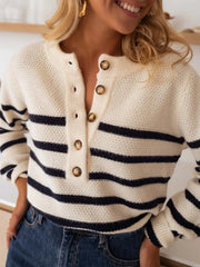 Close-up of a woman wearing a striped knit sweater with a button-up henley neckline