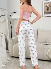back view of woman wearing pink camisole and floral print pants