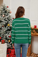 Back view of a woman wearing a green striped Christmas sweater.