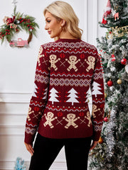 Back view of a woman in a red holiday sweater featuring gingerbread men and trees.