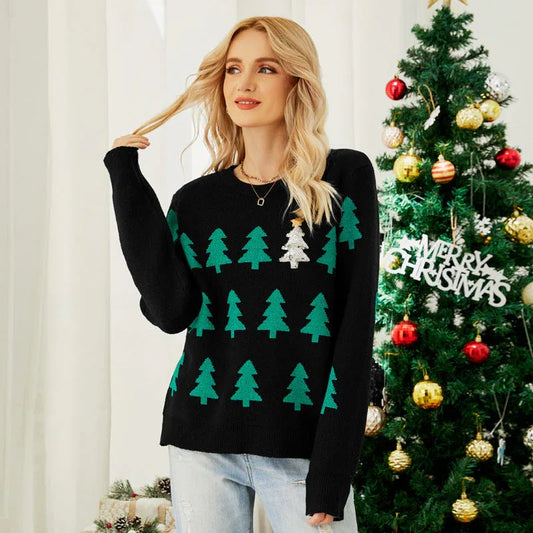 Woman wearing a black Christmas sweater with green trees and a sequined tree.