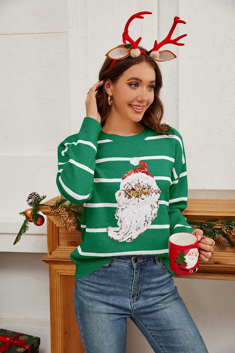 Woman wearing a green striped Christmas sweater with a sequin Santa Claus graphic, holding a Santa mug.