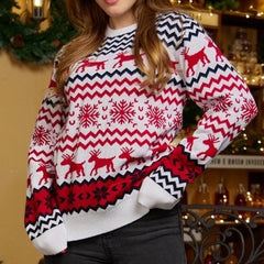 Woman wearing a white and red Christmas sweater with a reindeer and snowflake pattern.