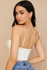 Close-up of the back of a white satin corset top